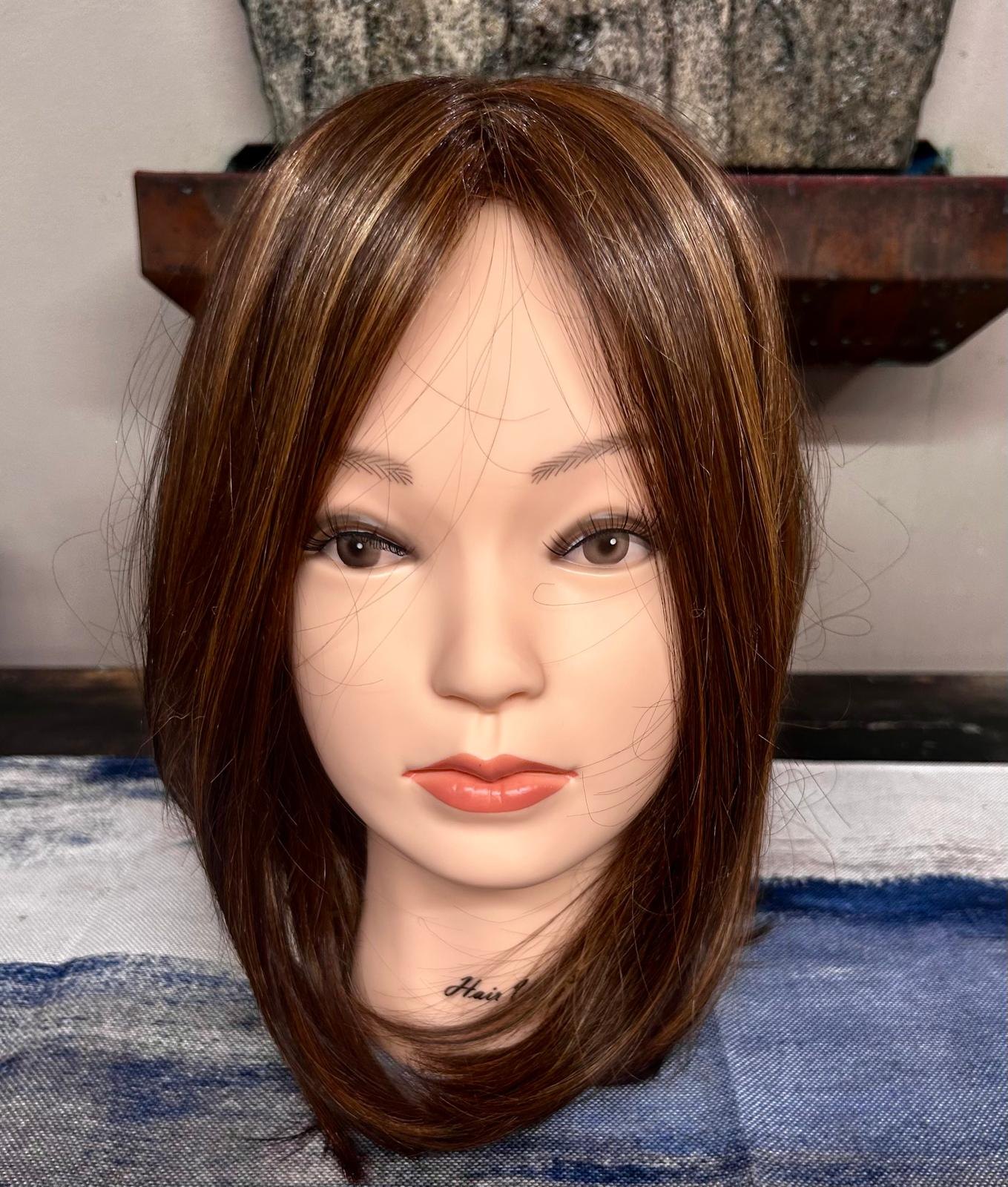 Warm brunette topper with dimensional highlights and long layers